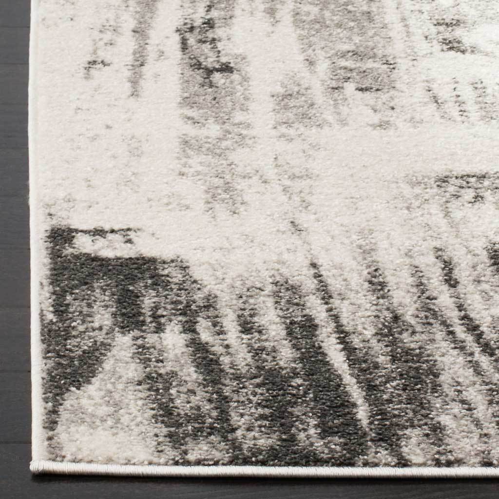 Textured ivory and gray pile with dark brushstrokes and neatly bound edges