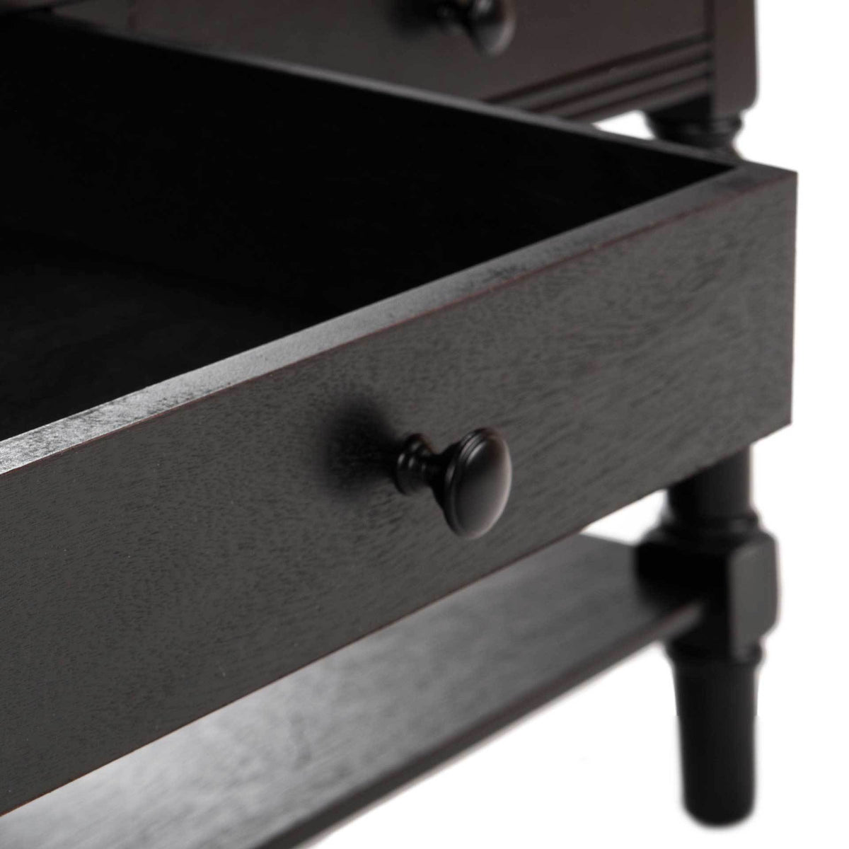 An open black drawer reveals storage space and a dark round knob