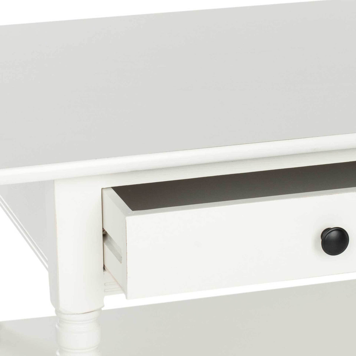 An open cream drawer features a dark round knob beneath the rounded tabletop