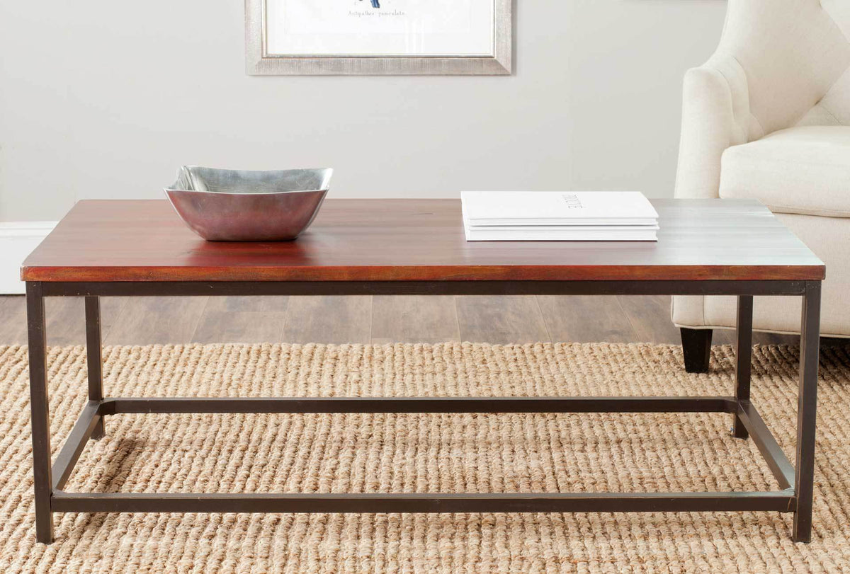 Maroon wood tabletop and airy metal frame add a warm accent beside a light upholstered chair.
