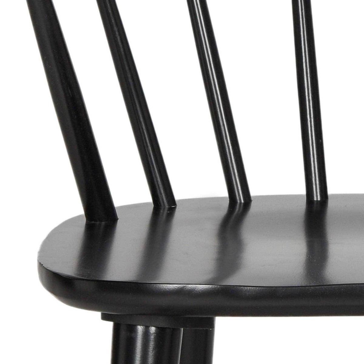 Smooth black wood defines the seat edge and the slim spindles rising from it.