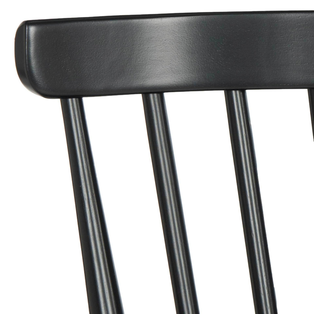 A smooth black top rail meets slender wood spindles in the airy backrest.