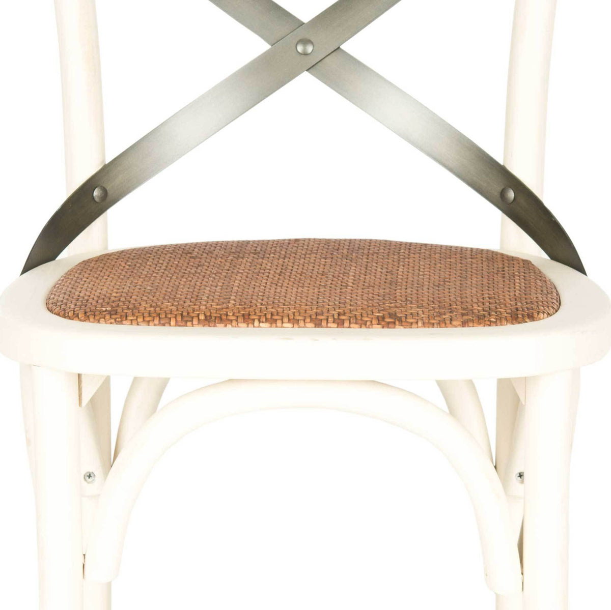 Close-woven rattan seat rests within an antique white wood frame beneath metal X-bracing