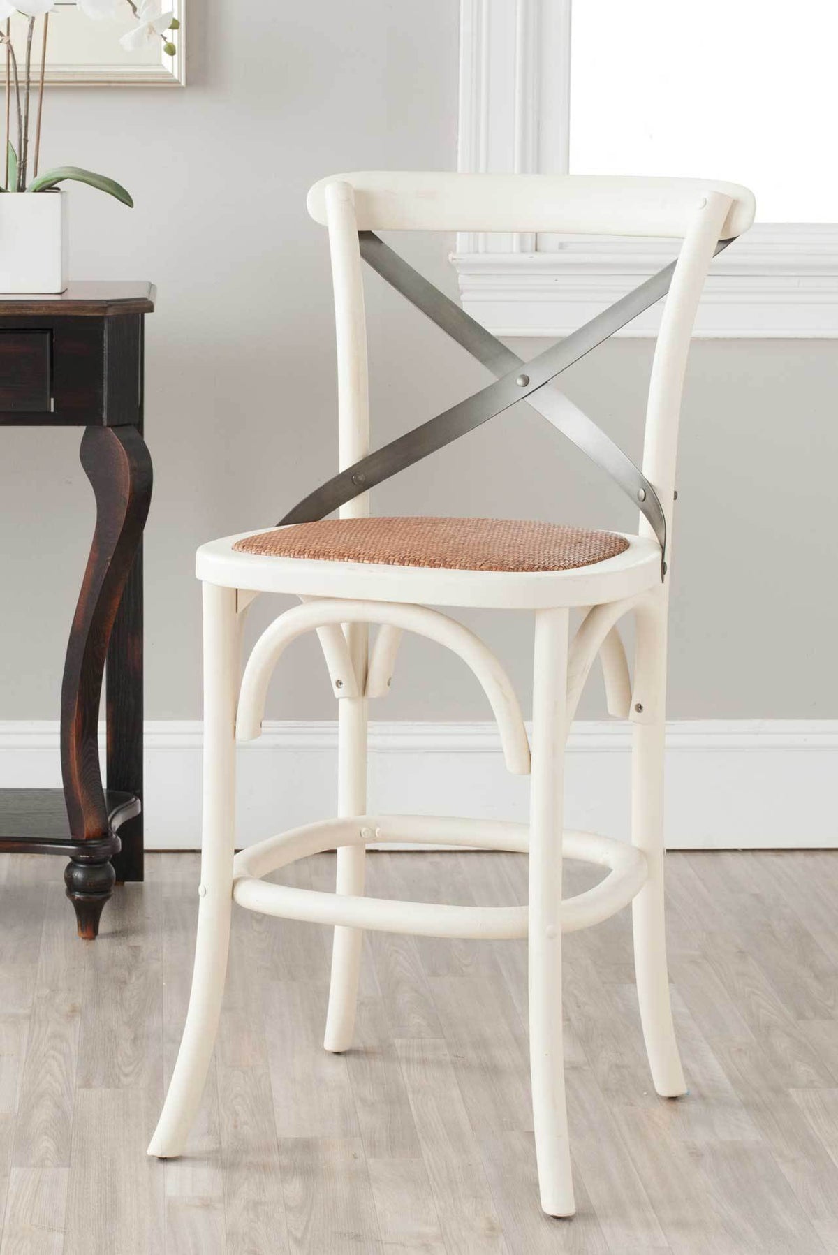 Antique white counter stool balances a textured rattan seat with a sleek metal X-back