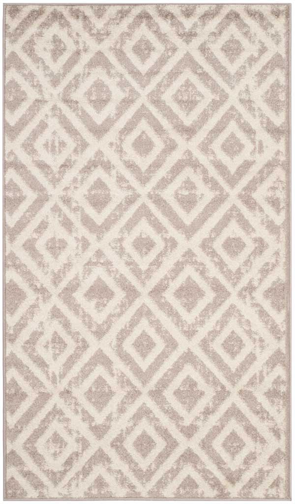 Interlocking mauve diamonds add a playful geometric touch to this 3-by-5-foot ivory rug