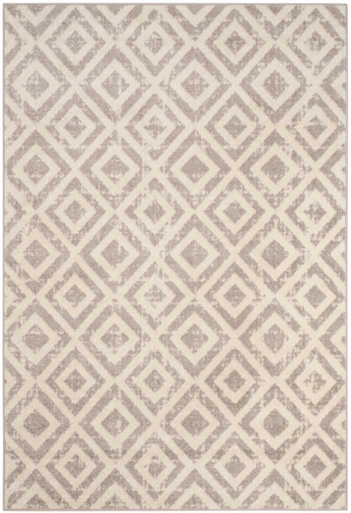 A soft mauve diamond pattern brings understated elegance to this 4-by-6-foot ivory rug