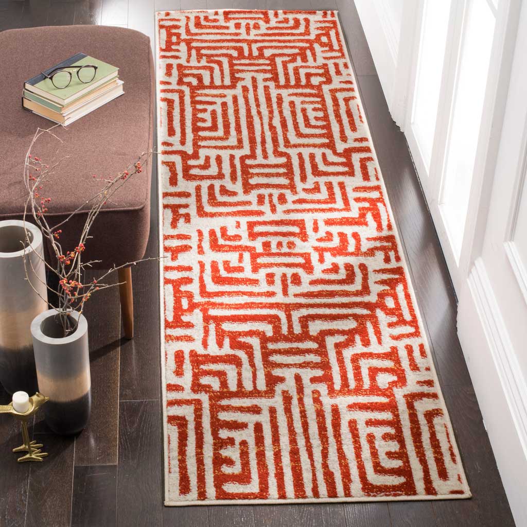 Terracotta geometric motifs add warmth to this ivory runner rug on dark wood floors