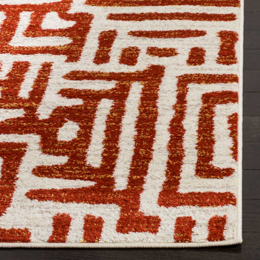 Deep terracotta pile contrasts with ivory pathways and a neatly bound edge.
