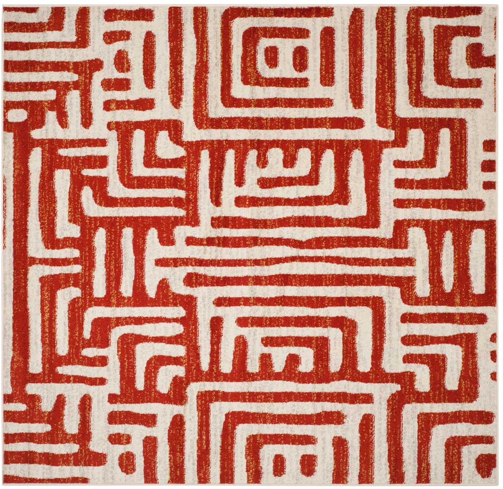 A square ivory rug features bold terracotta pathways and an interlocking design.