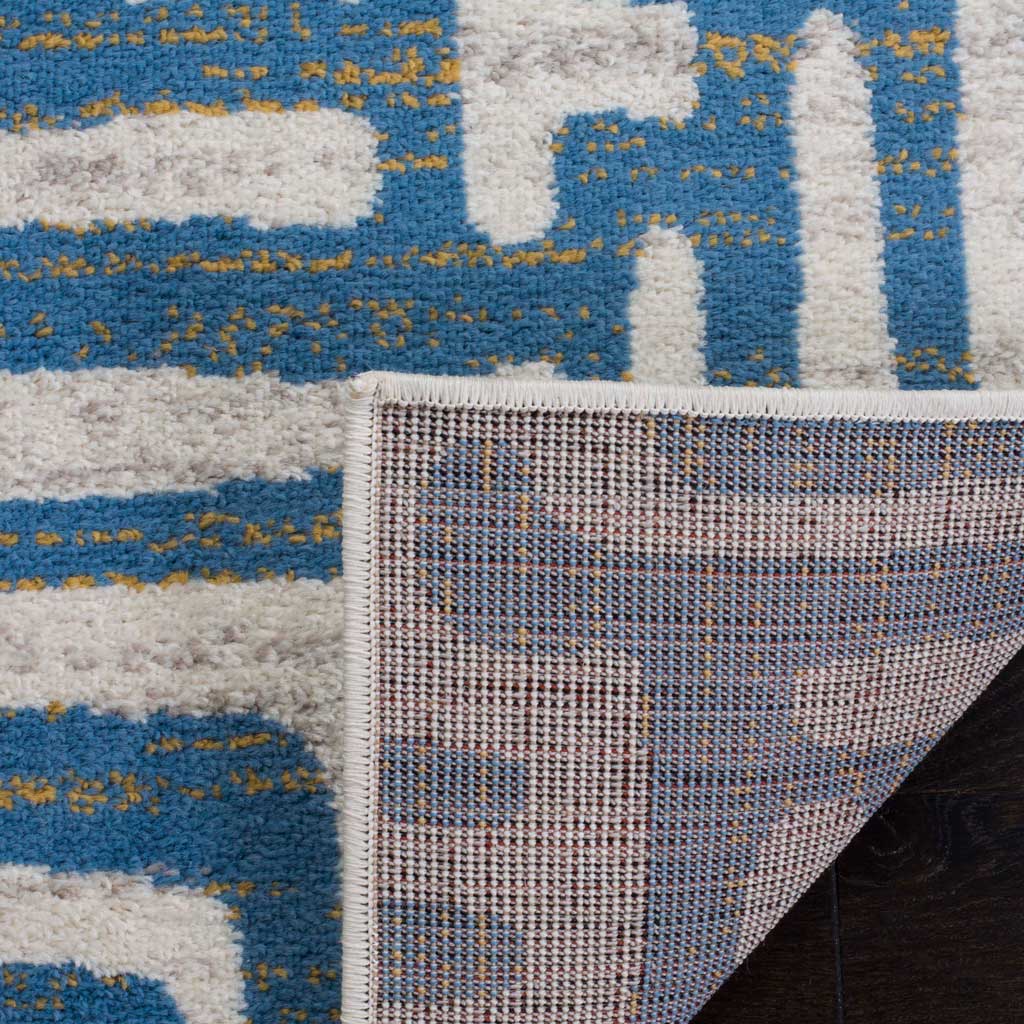 A tightly woven backing supports the ivory and light blue patterned pile.