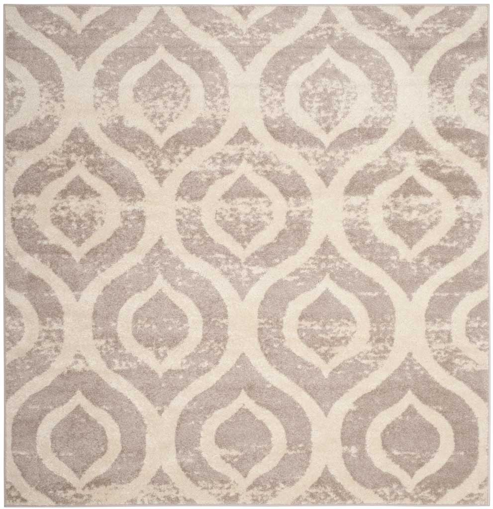 A square ivory rug pairs faded mauve medallions with an elegant repeating ogee pattern