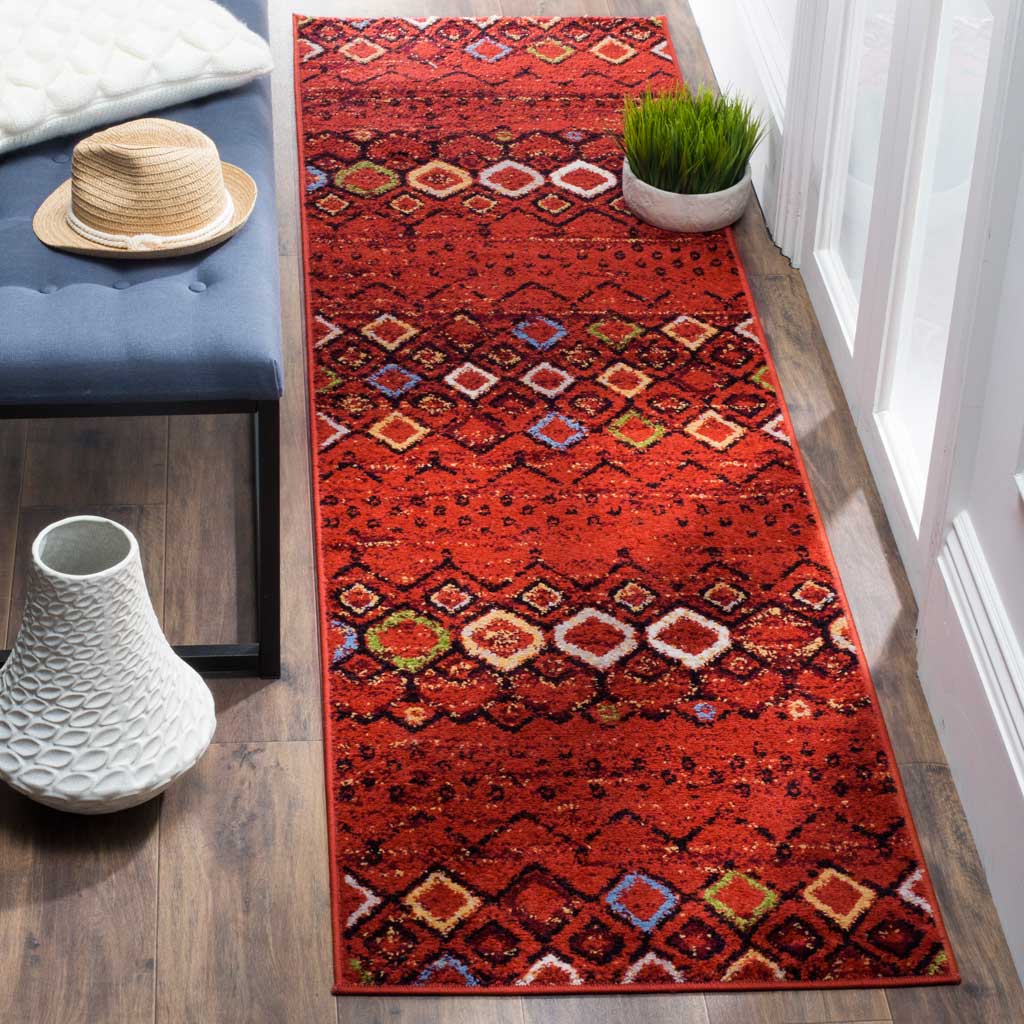 Warm terracotta tones and multicolor geometric motifs make this runner rug a lively floor accent.