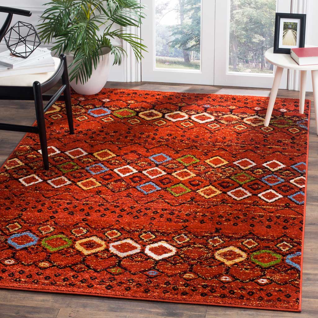 Warm terracotta rug fills a sitting area with colorful diamond bands and bohemian charm