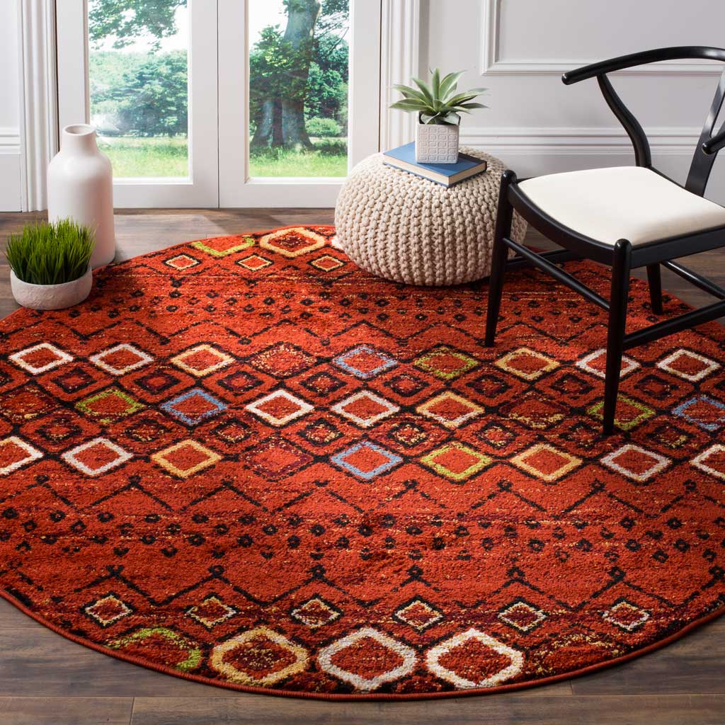 Warm terracotta tones and multicolor diamond rows bring energy to this round area rug