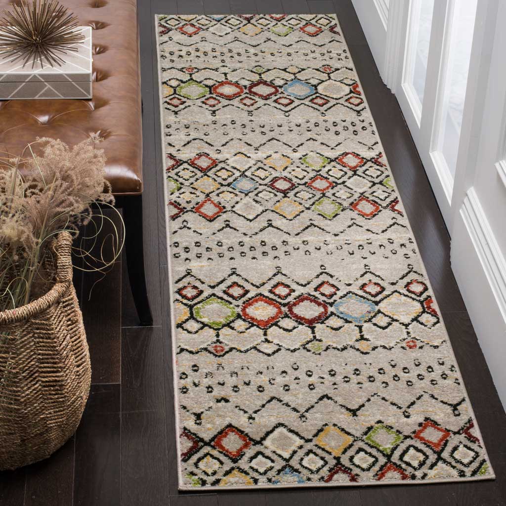 Playful red, blue, and green diamonds stand out on the light gray ground of this runner rug.