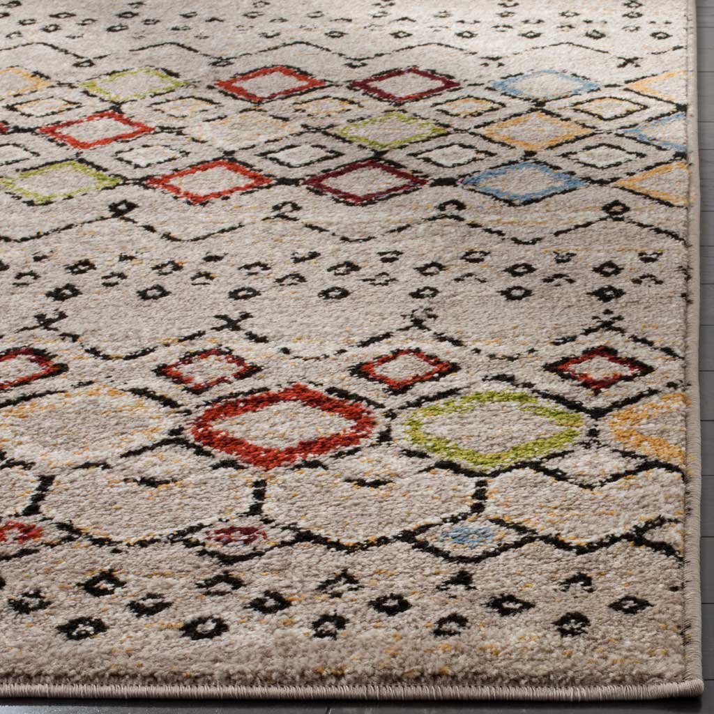 Textured light gray pile brings out colorful diamond motifs along a neatly bound edge