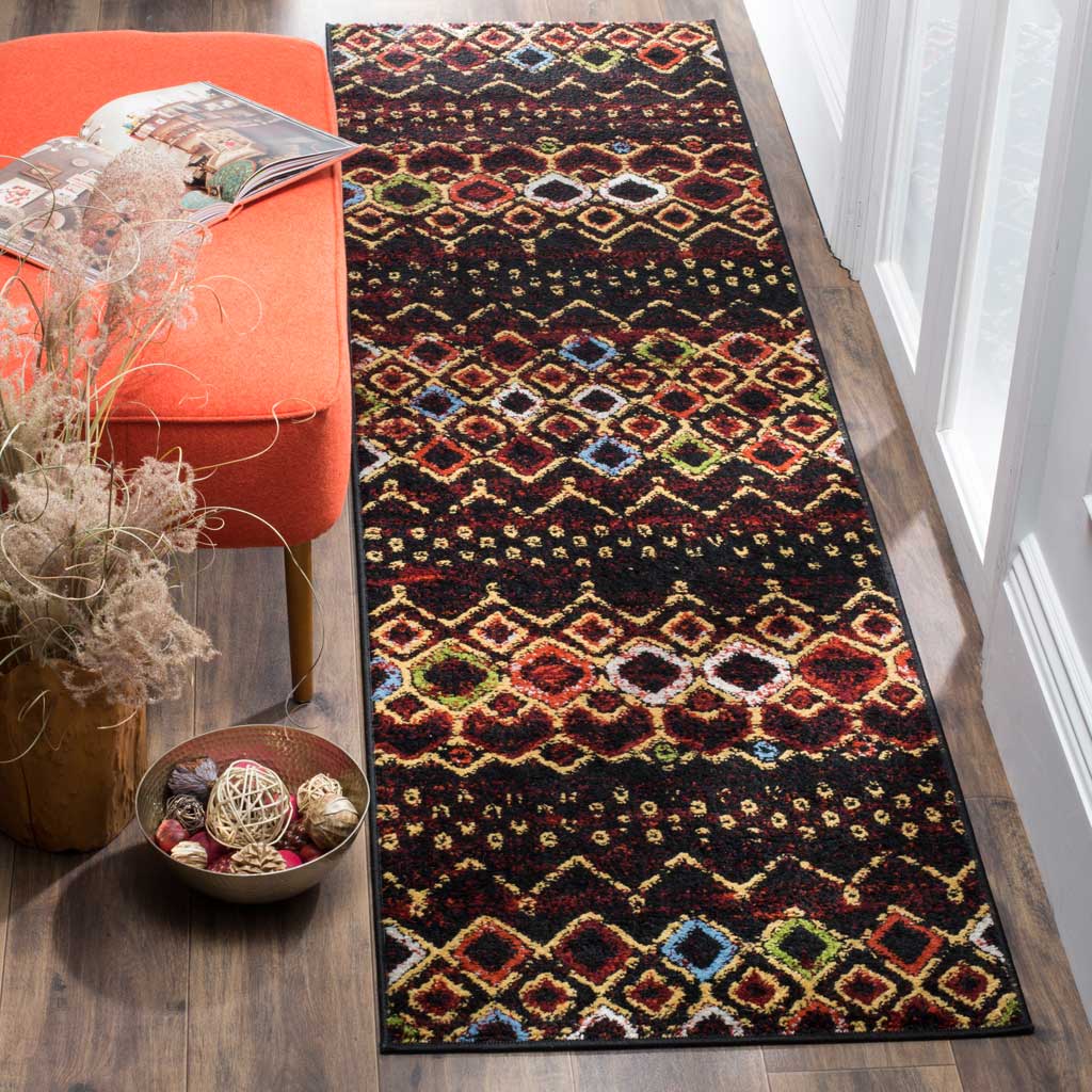 Bold diamond bands and colorful accents bring eclectic energy to this black runner rug.
