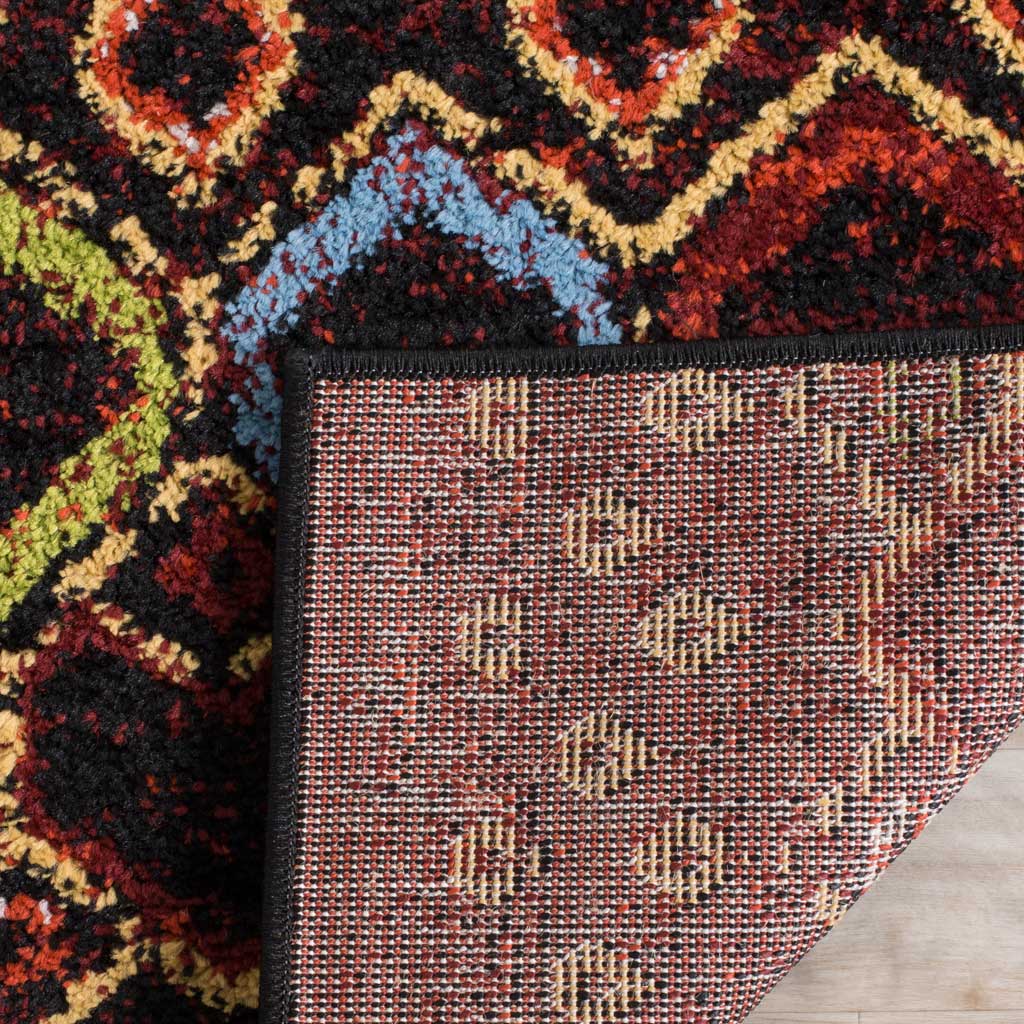 Woven jute backing supports the black rug's colorful pile and neatly finished edge
