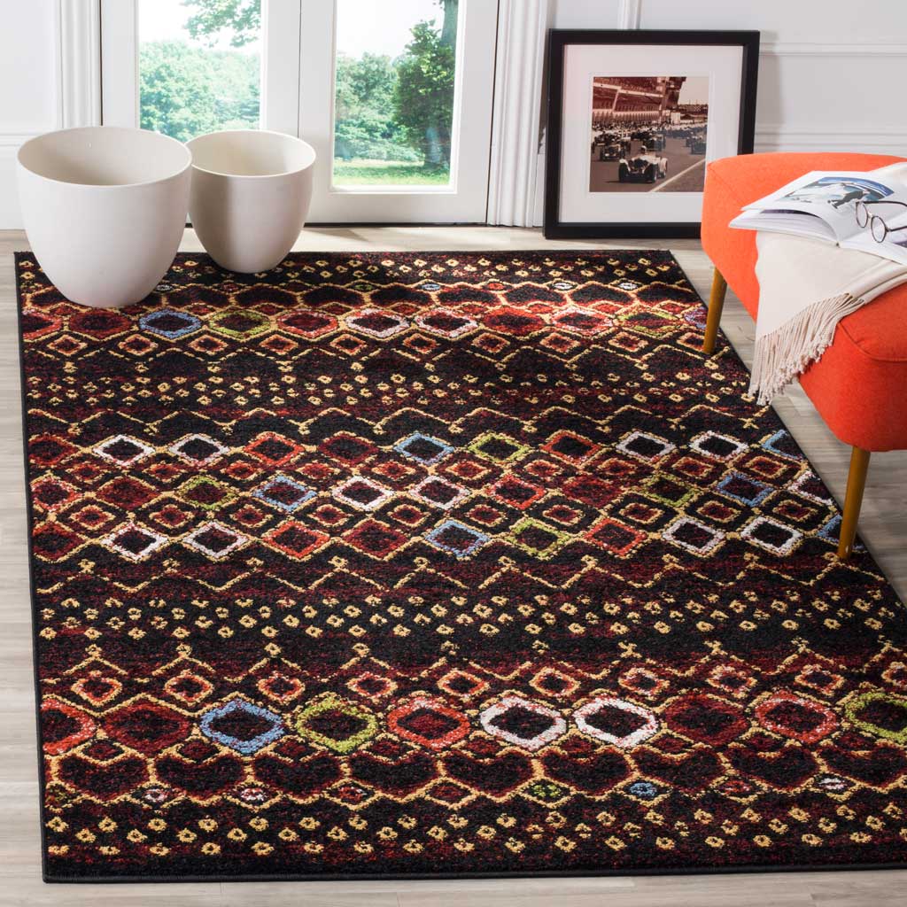 Colorful diamond bands enliven the black rug beside a bright orange chair