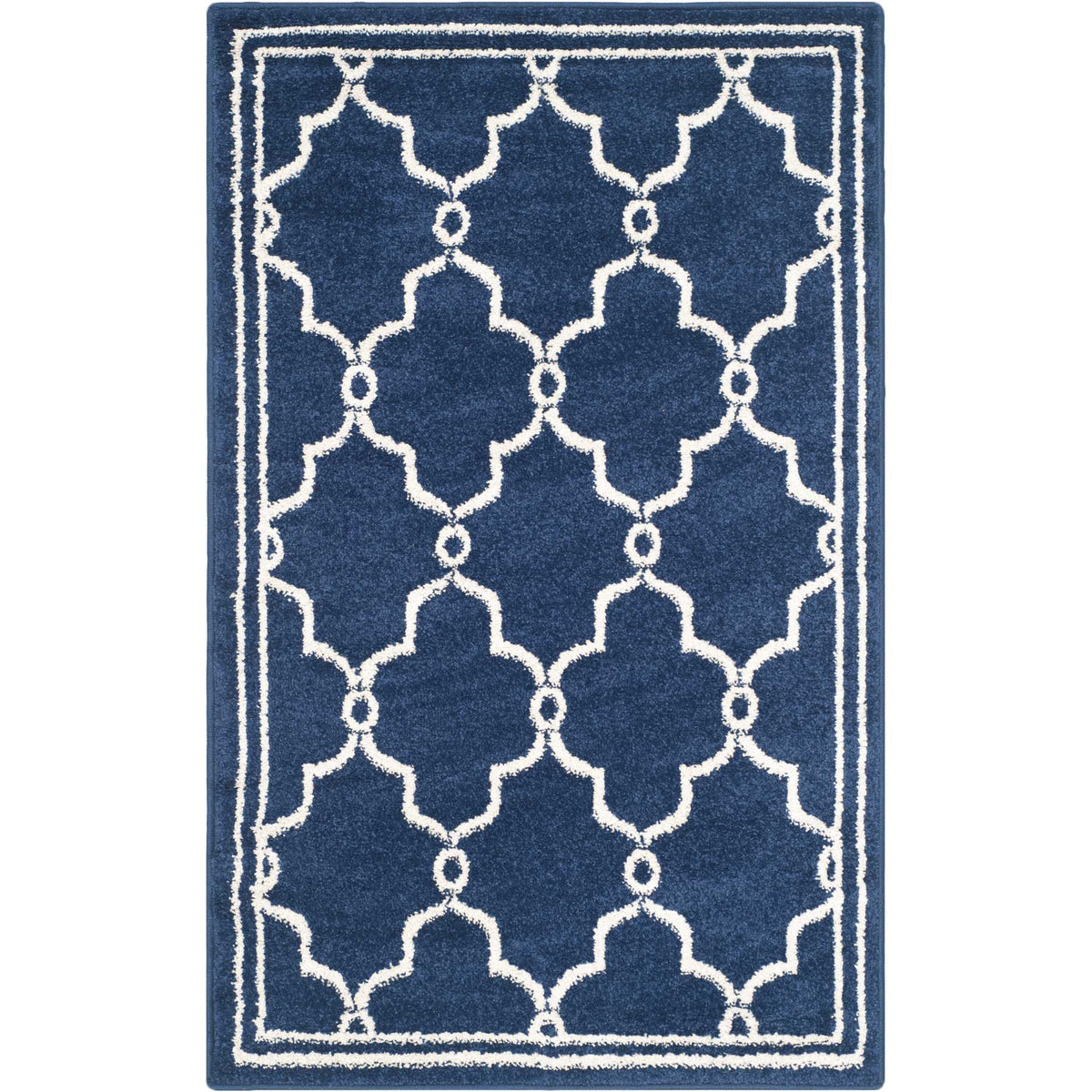 Compact navy accent rug features bold beige quatrefoil motifs and a slim border