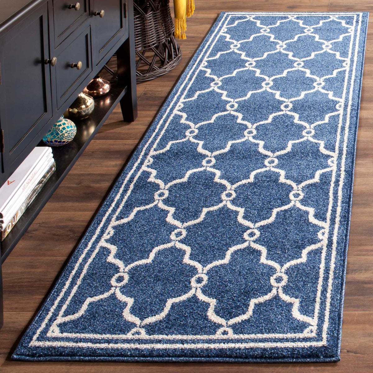 Navy and beige trellis runner adds bold geometric pattern beside dark wood furnishings