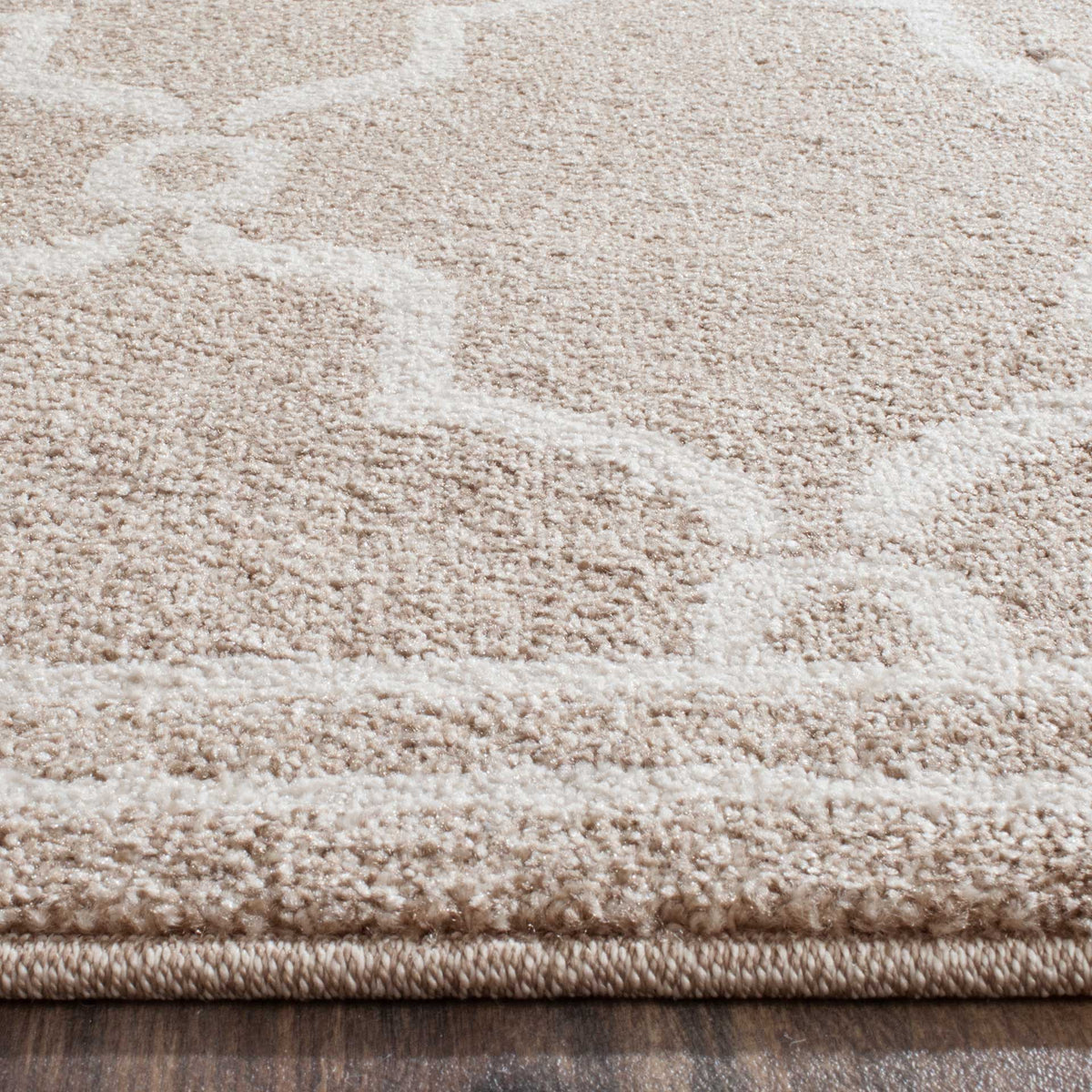Soft wheat pile and pale beige motifs extend to a neatly finished rug edge