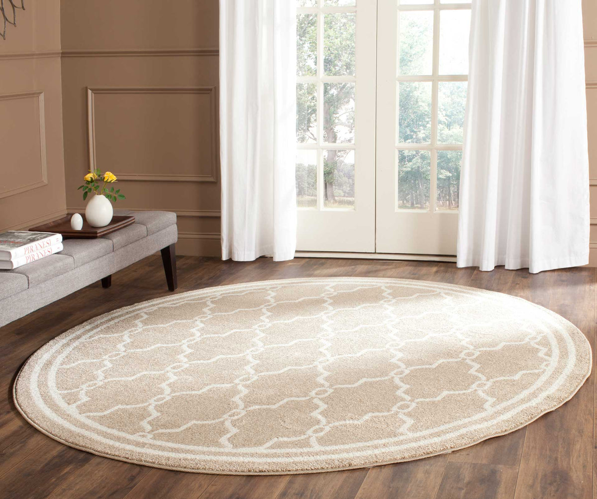 Wheat and beige round rug brings a graceful trellis pattern to a wood-floored room