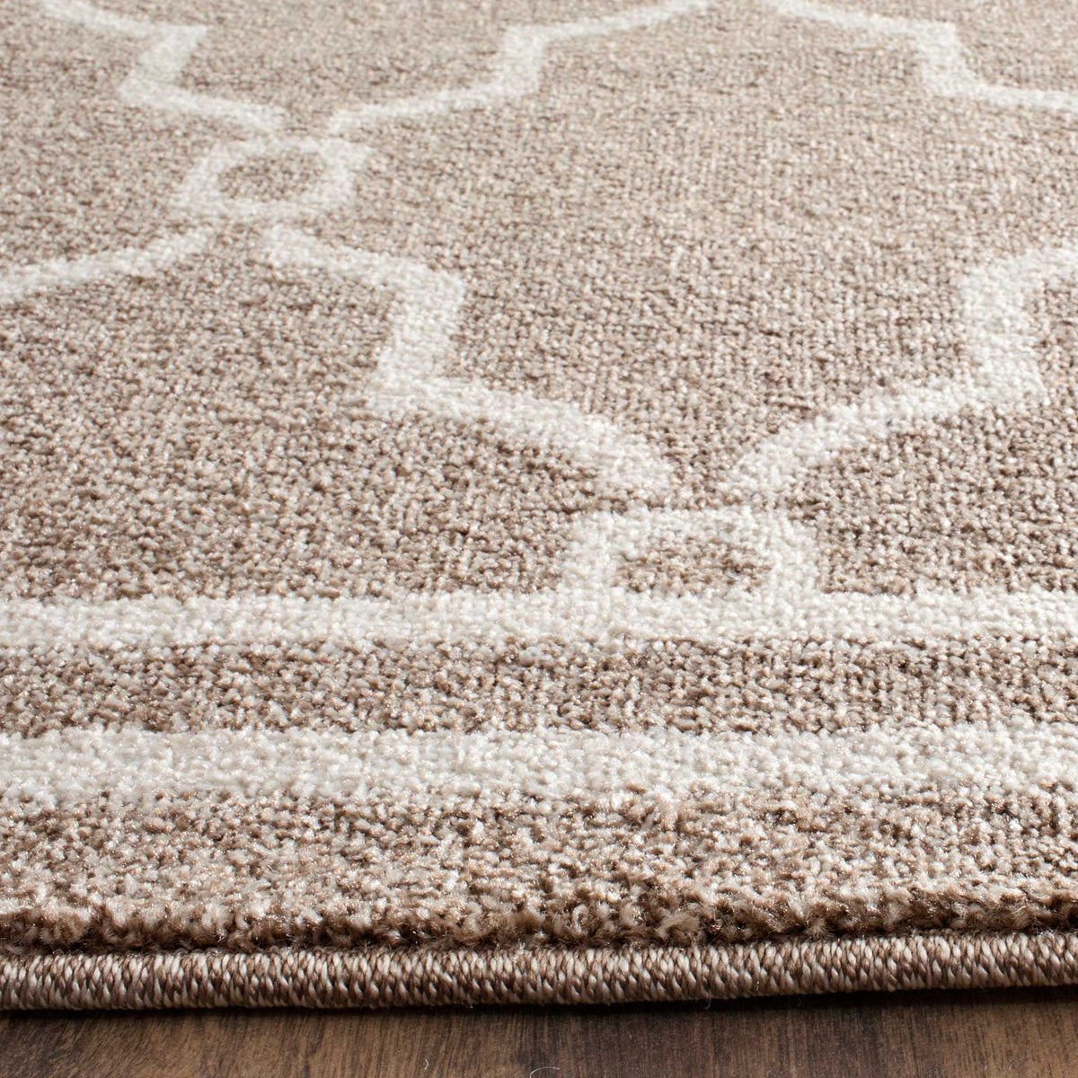 Wheat-colored pile meets beige trellis lines and a closely bound edge