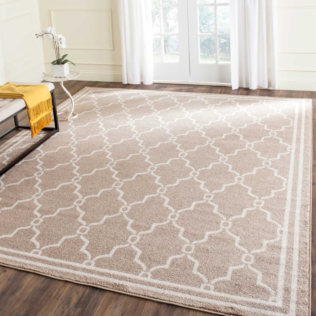 Wheat and beige trellis rug lends warm, patterned texture to dark wood flooring