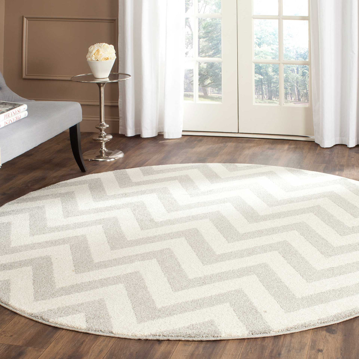 Soft gray zigzags bring subtle pattern to this round rug in a neutral living space.