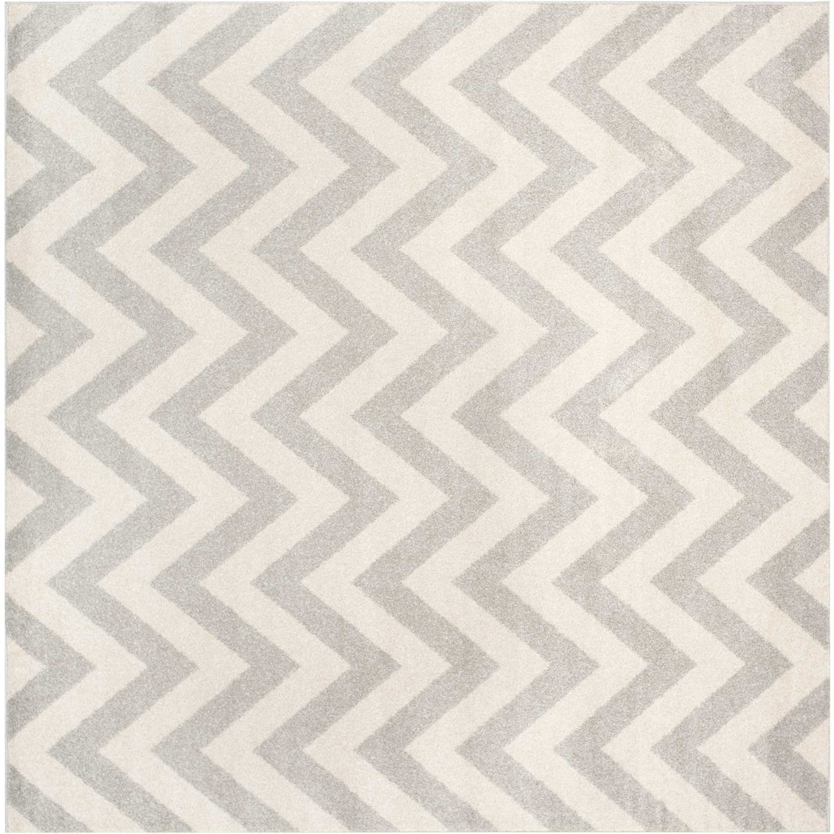 A square rug pairs soft gray zigzags with beige for balanced, understated pattern.