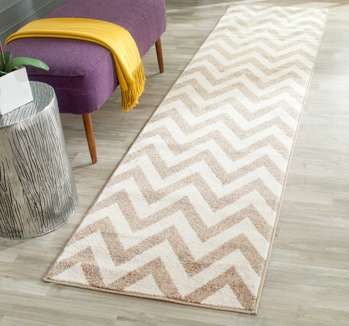 Wheat-toned zigzags add warmth and movement to a beige runner beside a lounge chair.