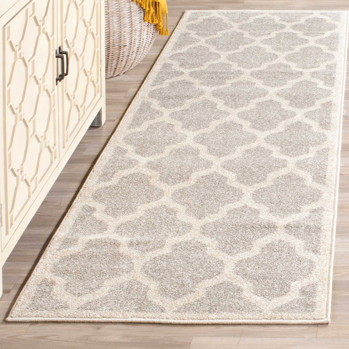 Muted gray motifs and creamy beige lines bring understated geometry to this runner rug