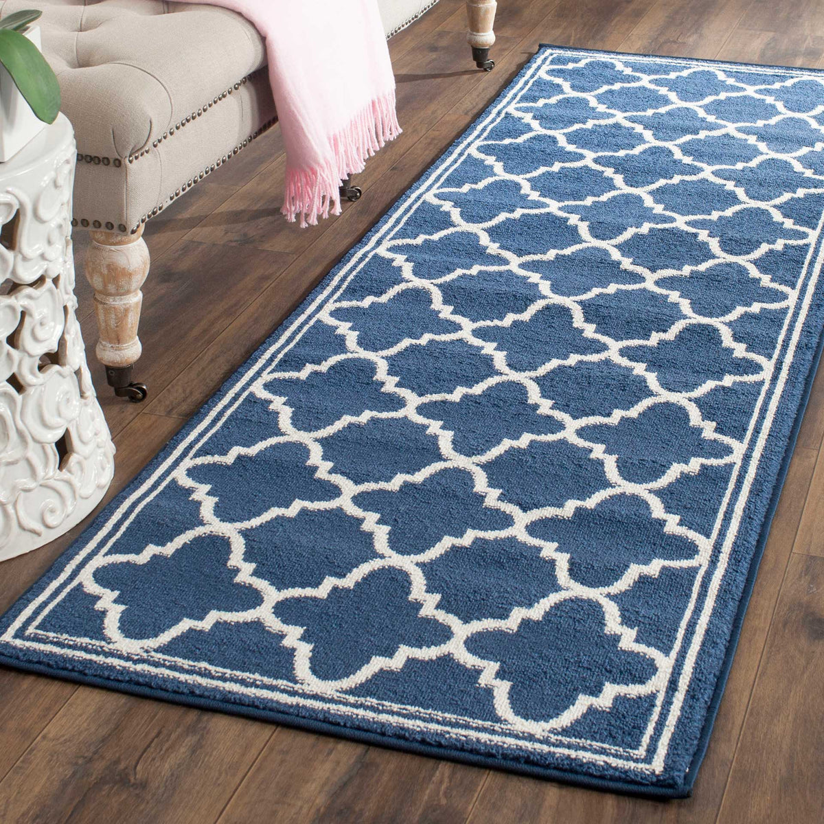 Beige trellis lines stand out against this rich navy runner, framed by a slim border
