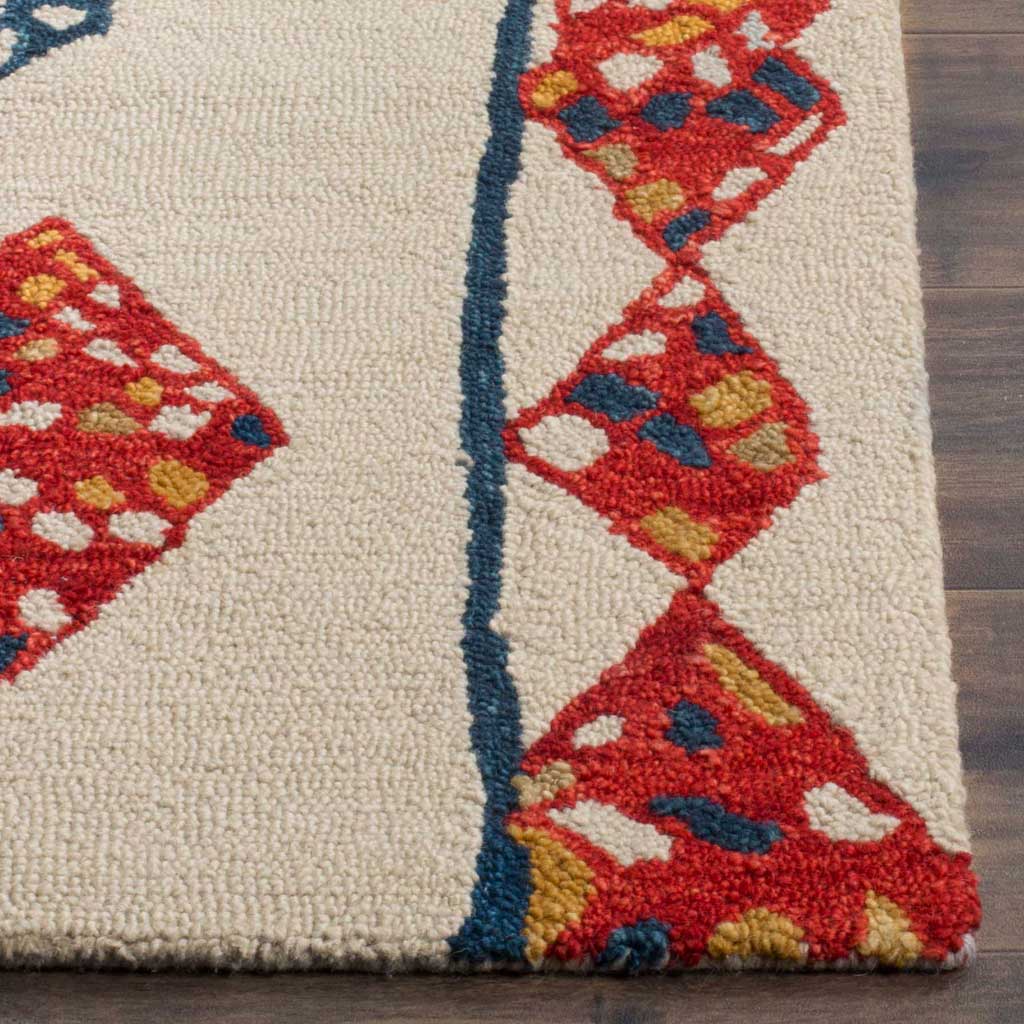 Dense ivory wool pile meets red geometric motifs accented in blue and gold along the rug's edge.
