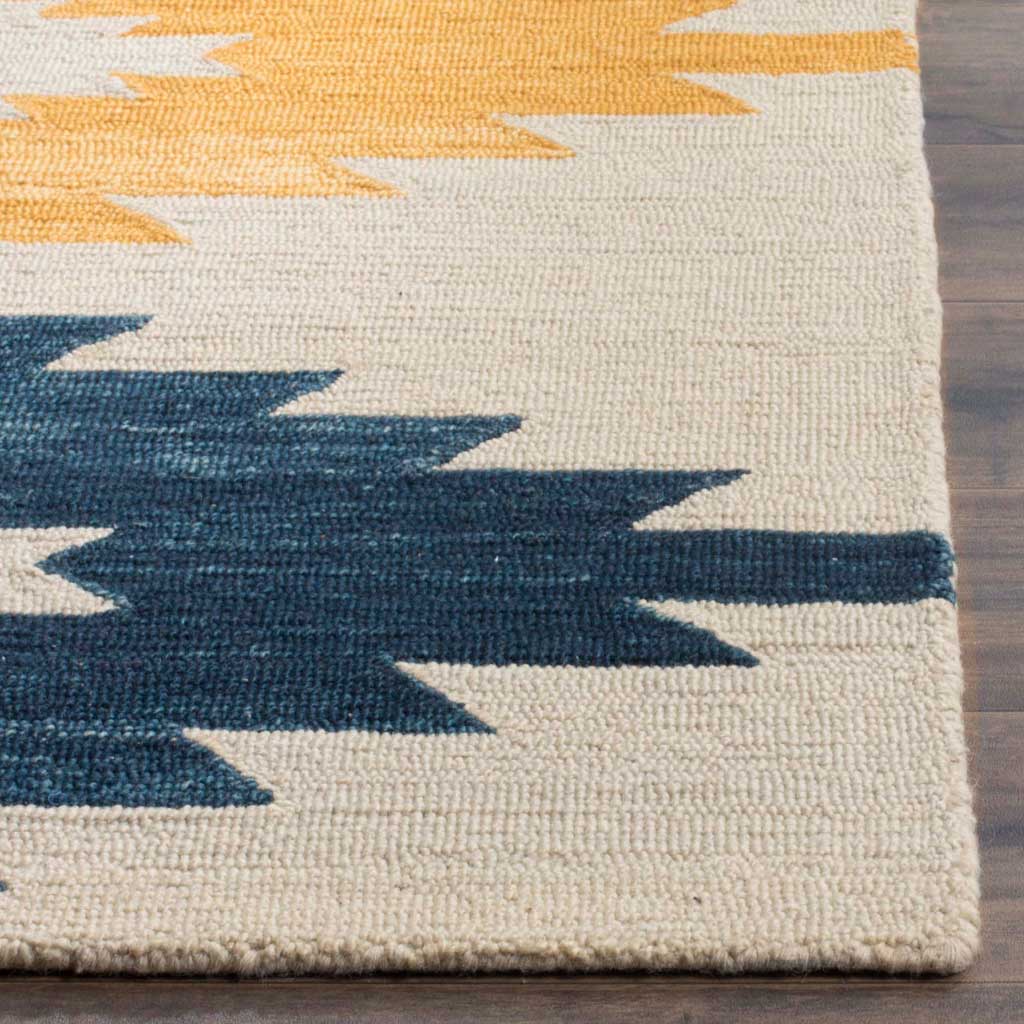 Textured ivory wool pile contrasts with gold and navy zigzags along a neatly finished edge