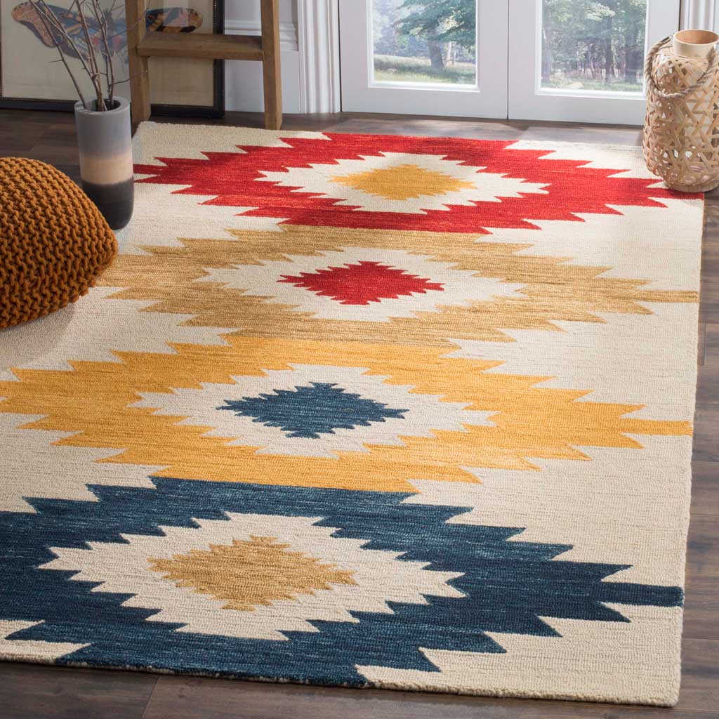 Red, tan, yellow, and navy stepped diamonds bring color and warmth to an ivory wool rug