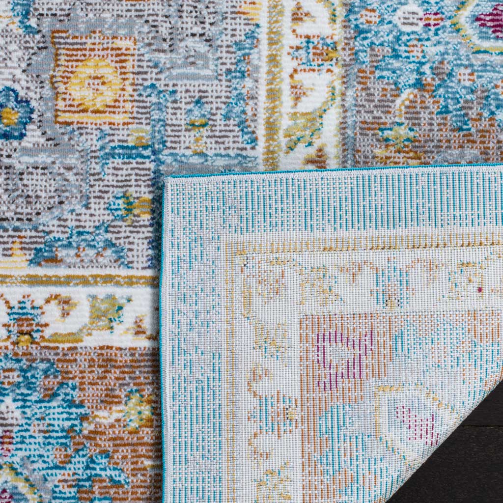 Woven backing peeks out beneath the rug's colorful, distressed floral design.