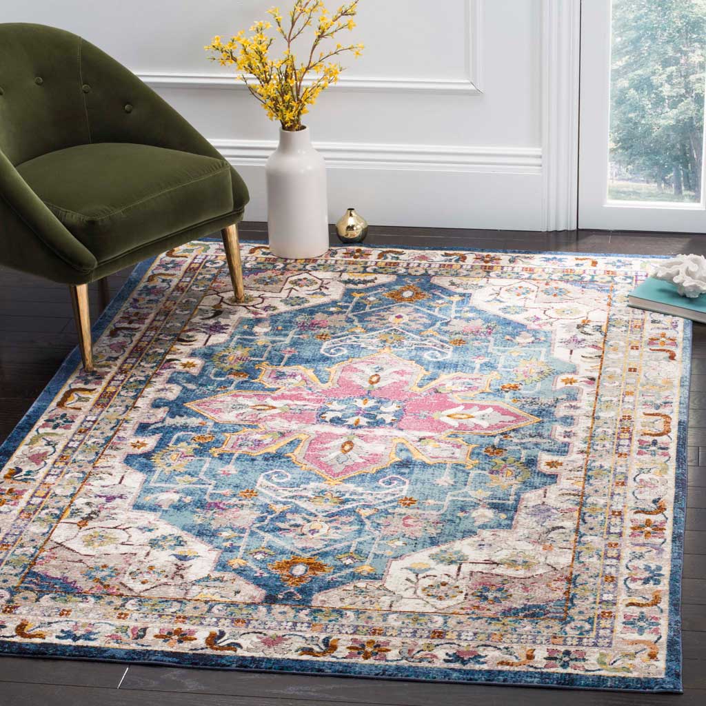 A vivid pink medallion adds warmth to this blue rug's scrolling floral design.