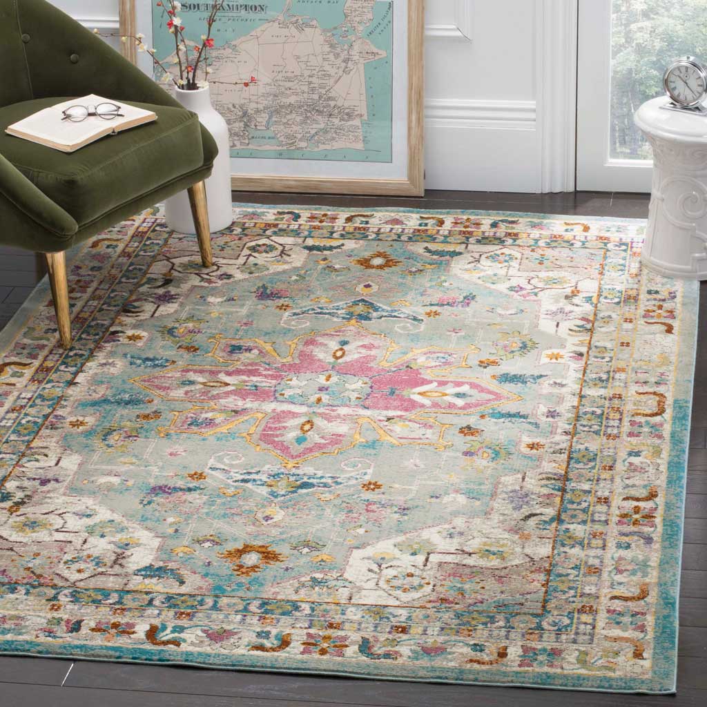 An airy green field and pink medallion give this ornate floral rug a vintage feel.