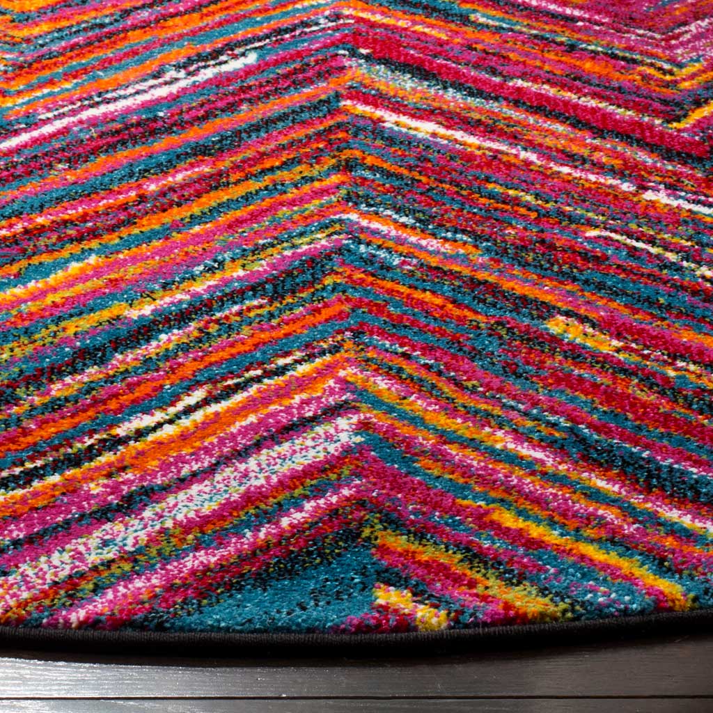 Colorful chevron bands highlight the rug's textured pile and dark bound edge