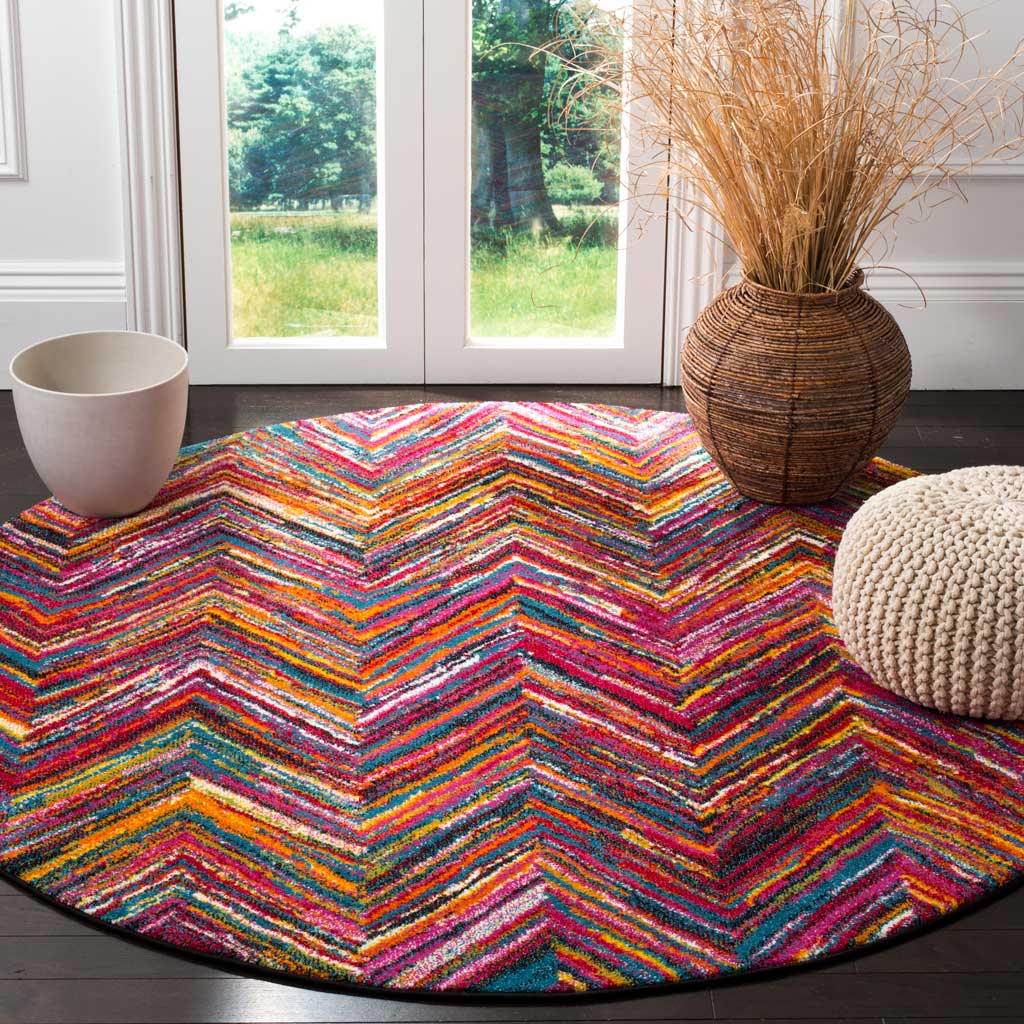 A vibrant round rug brings lively chevrons to a room with woven accents