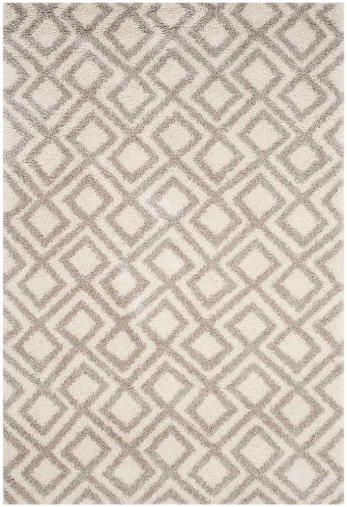 Neutral shag rug uses layered beige diamond outlines to add geometric depth to ivory pile.