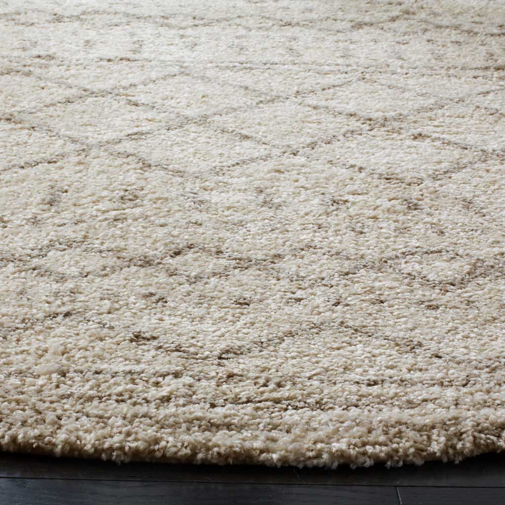 Dense ivory shag with fine beige lines offers a plush look and softly defined edge