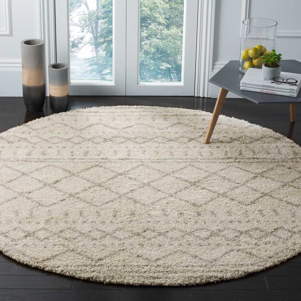 A layered diamond pattern gives this plush ivory and beige rug a relaxed, bohemian feel