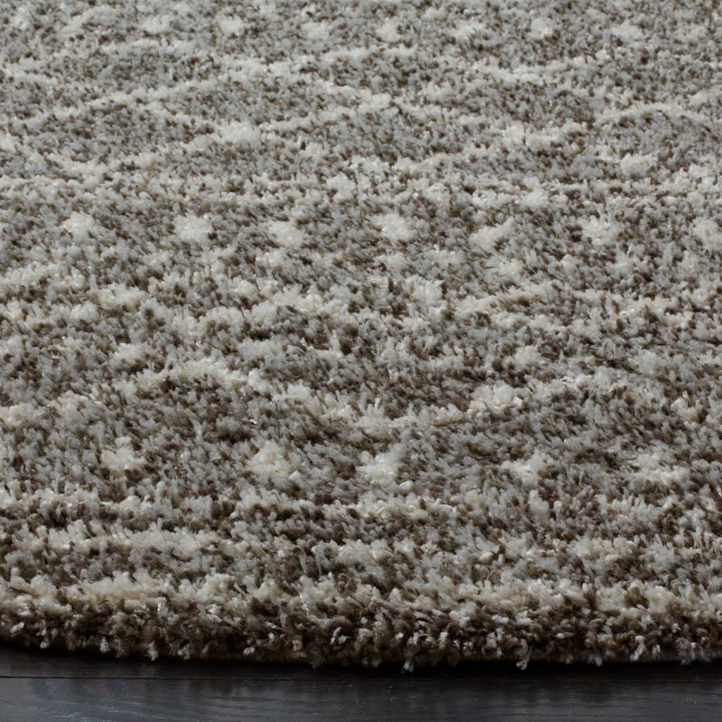 Brown and ivory fibers create rich texture along the rug's plush patterned edge