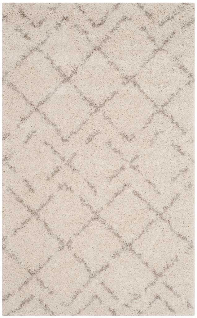 Compact ivory rug mixes soft, broken beige lines with an easygoing diamond pattern.