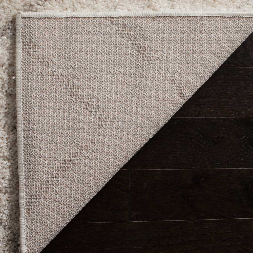 Light woven backing and secure binding provide a sturdy base for plush ivory shag.