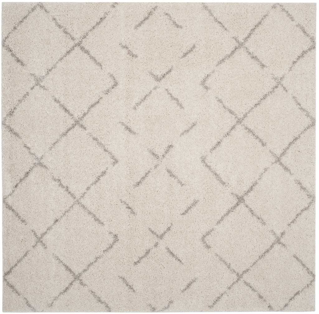 Square ivory rug features a delicate lattice of interrupted beige diamond outlines.