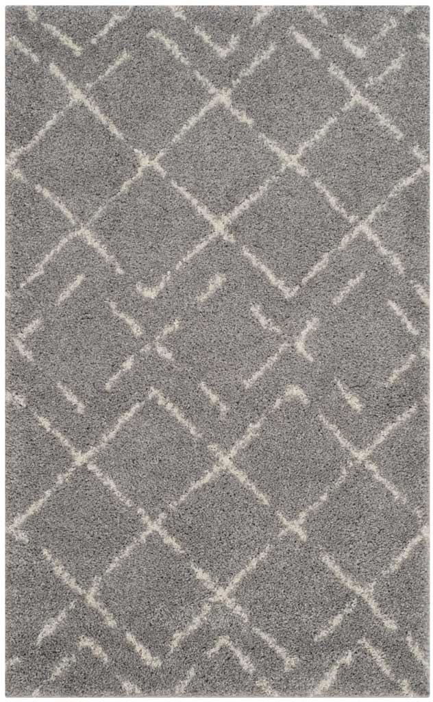 Small gray shag rug makes a graphic statement with staggered ivory diamonds.